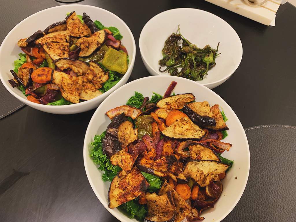 Vegan roasted veggie, kale, and rice bowls with blistered shishito peppers.